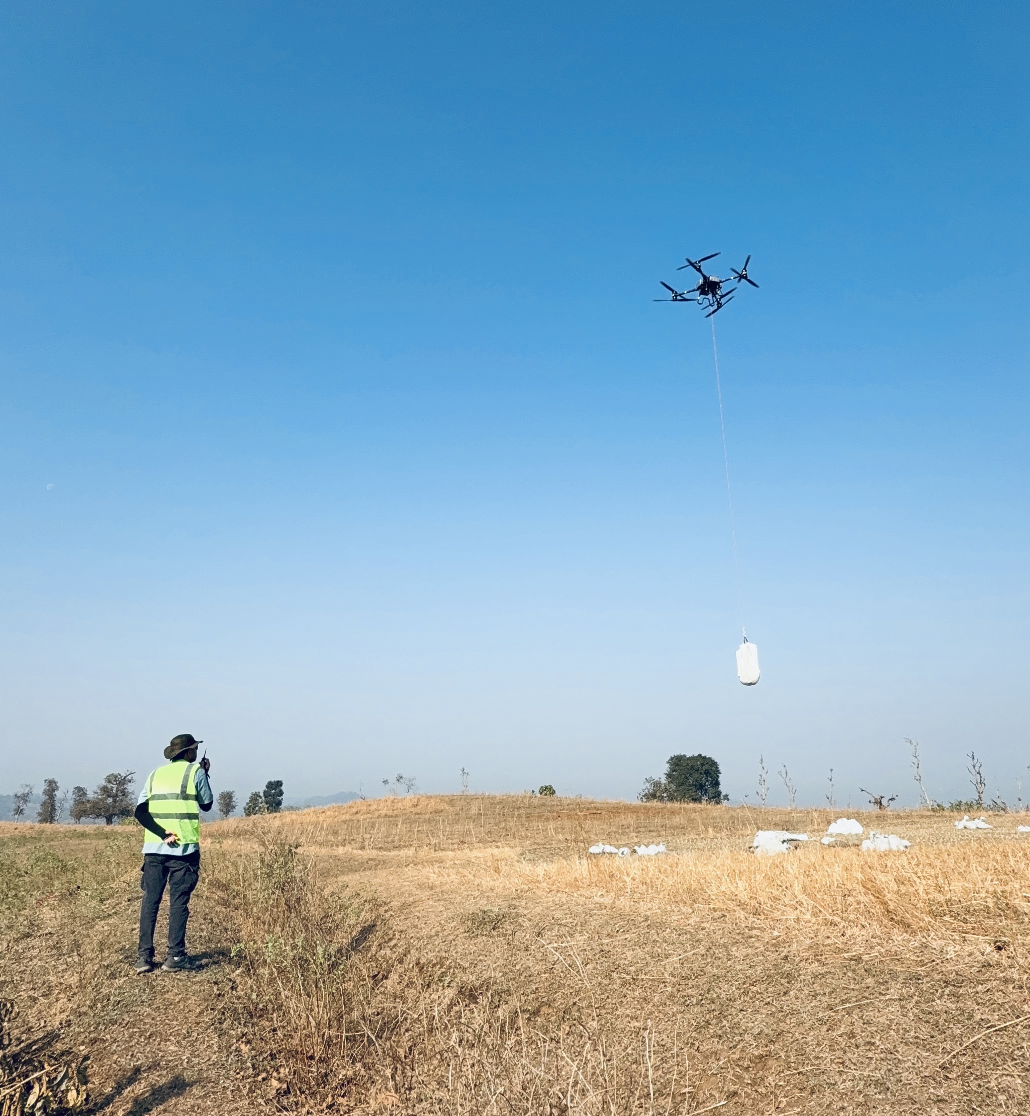 Drone laying a pilot line across a tower